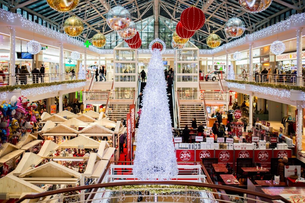 a tall white christmas tree in the middle of a mall