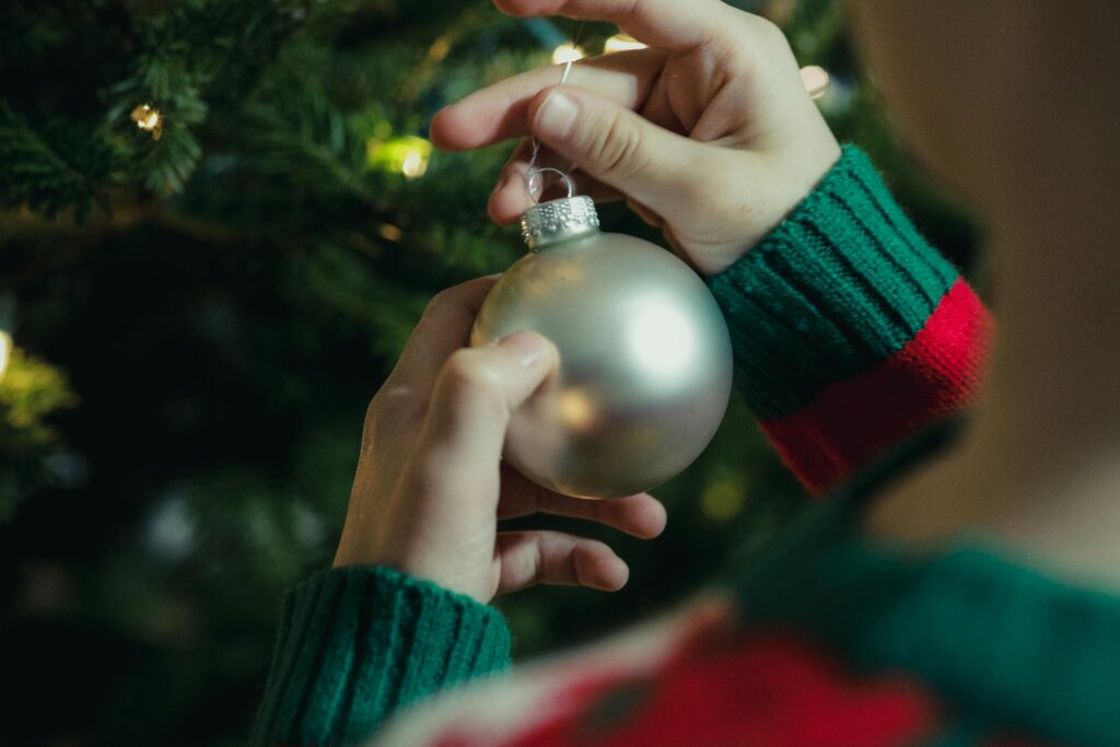 close up shot of a person holding a silver bauble